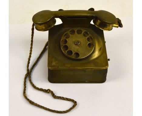 A 1930s novelty tin cigarette dispenser modelled as a telephone with a lighter set in the receiver, 13 x 12cm.