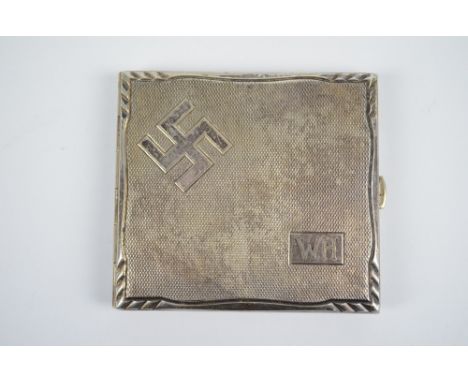 A Kraftalpacca white metal cigarette case of rectangular form with engine turned decoration, with swastika motif and W.H, len