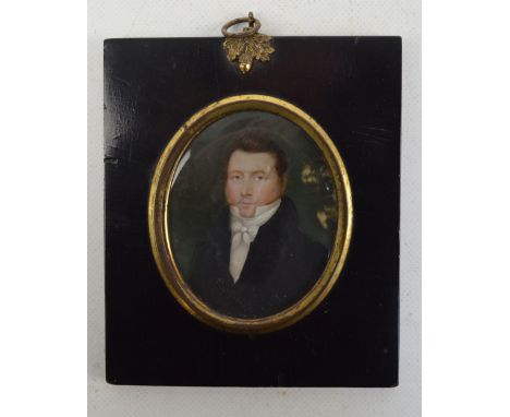 An early 19th century oval portrait miniature of a gentleman wearing white cravat and navy jacket, indistinctly signed 'Othon