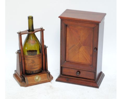 A walnut single drawer and single door cabinet, together with a large empty champagne bottle in pouring bracket (2).