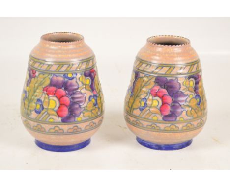 CHARLOTTE RHEAD; a pair of Crown Ducal ribbed baluster vases with tube line floral decoration within two ornamental bands, si