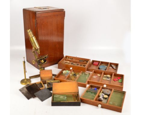 A c.1900 mahogany cased brass monocular microscope with screw-in tube and tripod support, five drawers to the case set with v
