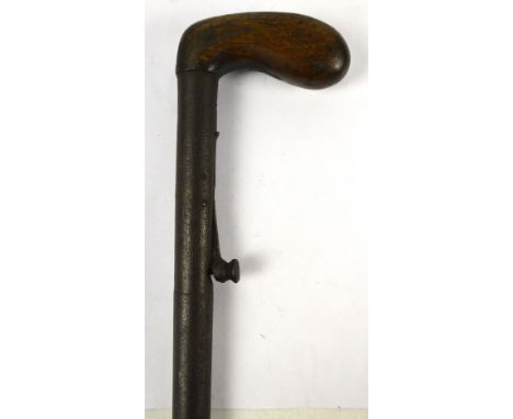 A 19th century gamekeeper's gun percussion cap walking stick with stained beech grip handle, length 88cm, also a further 19th