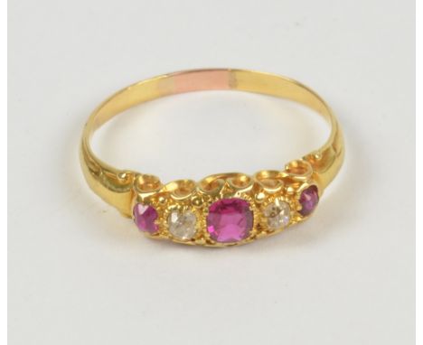 A yellow metal ruby and diamond five stone graduated ring in scroll setting, size R, approx 2.6g.
