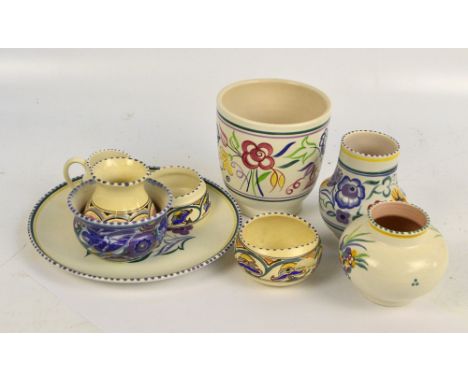 POOLE; a group of various items including a jardinière, diameter 14cm, three vases, two bowls and a cream jug (7).