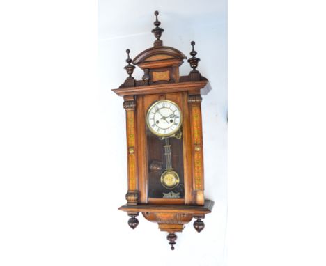 A late 19th century walnut eight day spring driven Vienna type wall clock by Junghans, the enamel dial with ring of Roman num