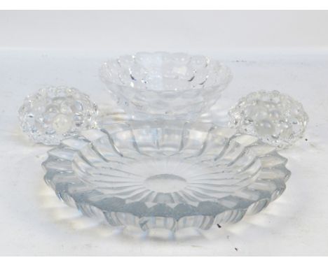 ORREFORS; a raspberry glass bowl, diameter 19cm, and a pair of matching candle holders, all marked to base, and an open glass