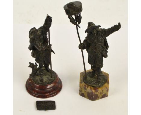 A pair of late 19th century bronze figures, one depicting a rat catcher, the other depicting a man with two dogs, tallest hei