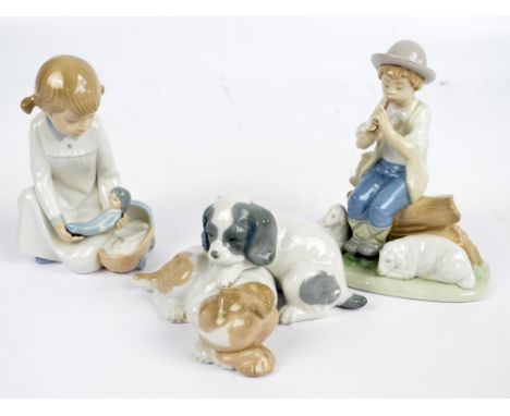 NAO; three figures; a boy shepherd playing his pipe, a small girl playing with a baby doll and crib, and two puppies (3).