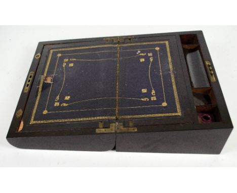 A Victorian coromandel writing slope with inlaid mother of pearl decoration and curved front, with fitted interior including 