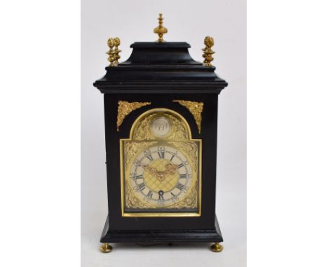 A late 18th century Dutch ebonised bracket clock with brass finials above arched dial inscribed '1774', above chapter ring se