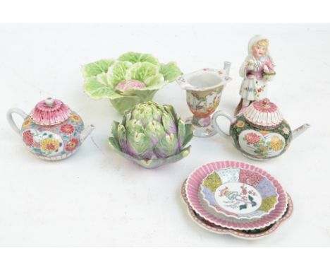 A 19th century helmet shaped cream jug decorated in the chinoiserie manner, two floral decorated teapots, porcelain figure, e
