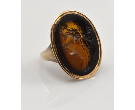 A Georgian rose metal ring set with large oval intaglio depicting the head of a young woman, 3.5 x 2cm, size approx L, approx