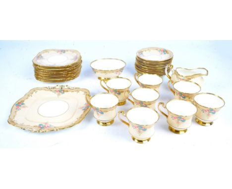 A Paragon part tea service, consisting eight tea cups, eleven saucers, a cream jug, an oval shaped sugar bowl, eleven square 