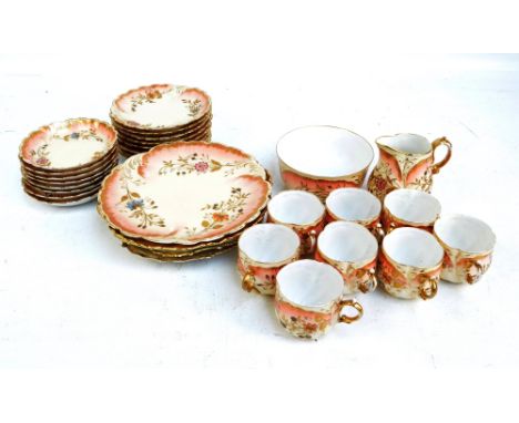 A part Limoges blush tea service consisting eight tea cups and saucers, eight tea plates, a sandwich plate, a milk jug, a slo