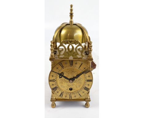 A reproduction brass lantern clock, the chapter ring set with Roman numerals and inscribed Smiths, with eight day movement no