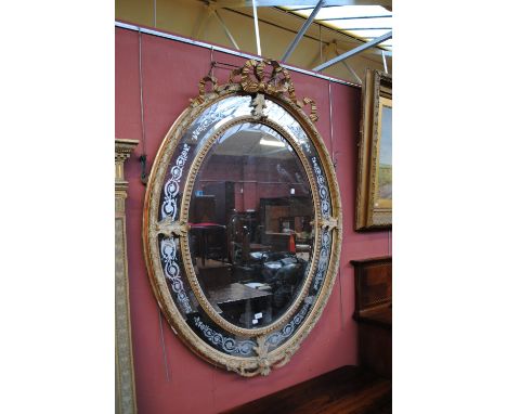 A impressive mid 19th century oval gilt frame mirror, central mirror surrounded by beaded moulding and secondary scrolling fo