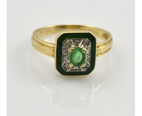 A 14ct yellow gold emerald and diamond dress ring, the central oval raised emerald surrounded by four diamond chips and with 