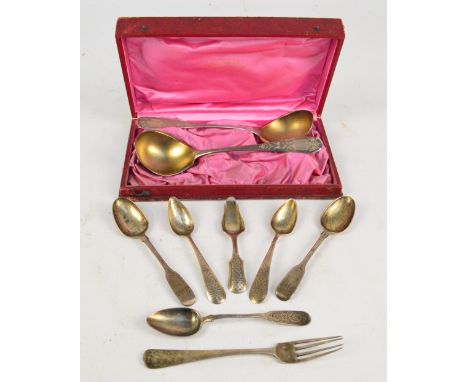 A pair of late 19th/early 20th century Dutch sauce ladles, with bright cut decorated handles, vacant shield shaped cartouches