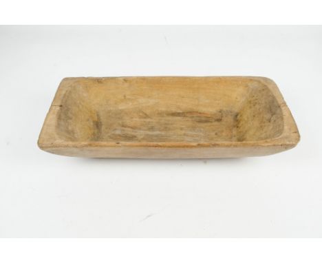 A rustic pine one-piece dough trough with adzed shaping, length 53cm.
