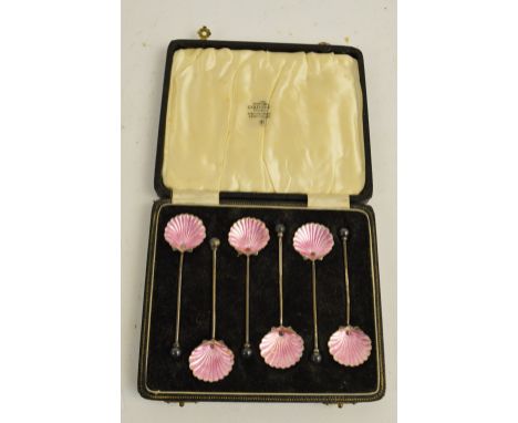BERNARD INSTONE; a cased set of six George V hallmarked silver and enamel coffee spoons, the scalloped shell bowls decorated 