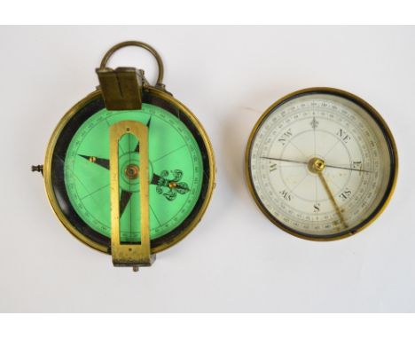 A 19th century brass circular pocket compass with ring loop attachment, removable cover and hinged sighting arm, diameter 7.7