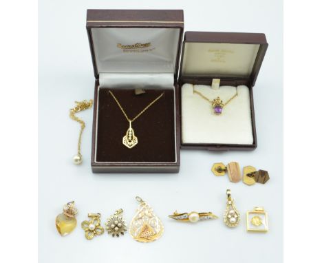 A collection of various 9ct gold and gold plated pendants, including an amethyst set example and a 14ct gold pear shaped pier