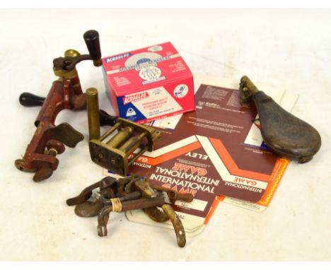 A collection of shooting related items including a combination rollover tool, a leather shot flask, a 12 bore capper decapper