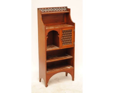 An Arts & Crafts free standing smoking cabinet, with turned bobbing gallery above shelf, cupboard door, a compartment and two