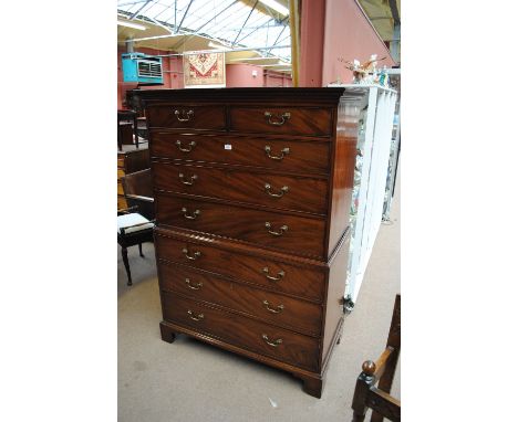A George III mahogany chest on chest, the moulded dentil cornice above two short and three long graduated drawers, raised on 
