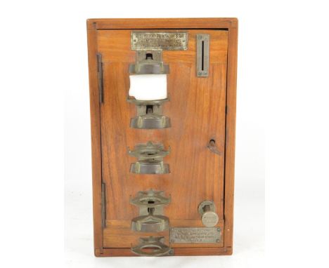 An unusual early 20th century walnut cased hotel night light dispenser, bearing plaque inscribed 'The British Automatic Suppl