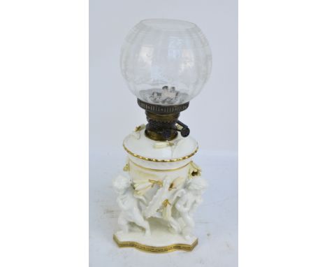 MOORE BROS; a cherubic and floral decorated lamp base with etched globular shade and Greek key gilt heightened foot rim, heig