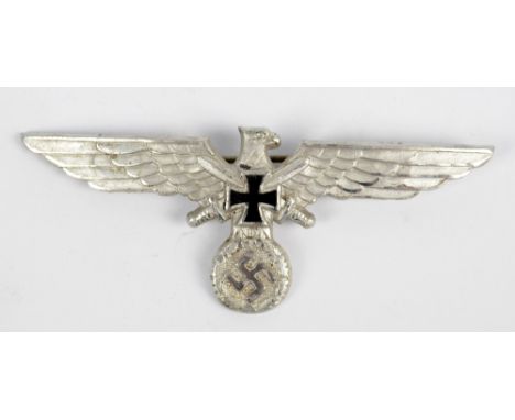 A German WWII period Third Reich badge, width 9.5cm and a trench art lighter (2).