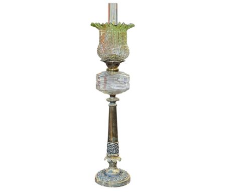 Victorian ornate brass column oil lamp with clear glass reservoir and vaseline shade, 81cm.