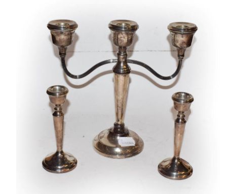 An Elizabeth II weighted silver three light candelabra by A T Cannon Ltd, Birmingham 1973, together with a similar pair of sm