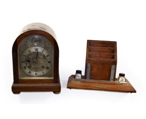 A Reid &amp; Sons checkered string inlaid mahogany veneered striking mantel clock, the silvered arch dial with slow fast subs