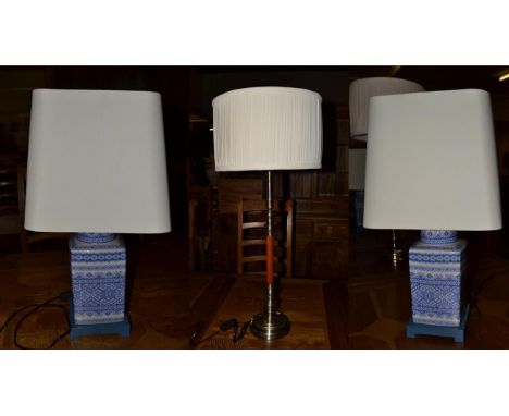 A pair of modern Chinese style blue and white pottery table lamps, together with another modern lamp of column form (3)