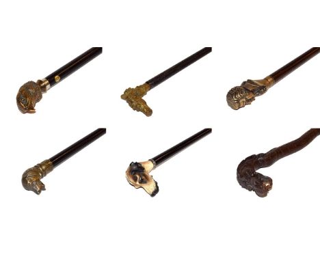 ~ An Oriental carved hardwood walking stick formed as a dragon and a collection of other walking canes with zoomorphic and fi