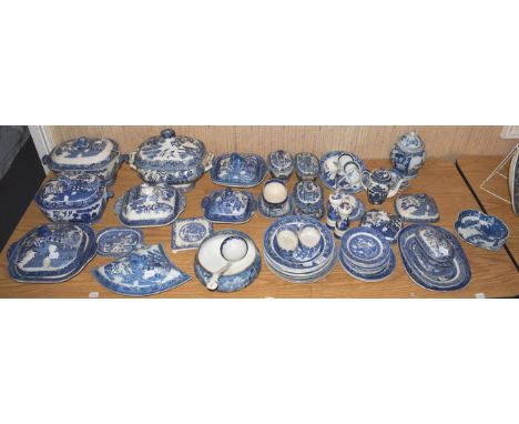 A quantity of 19th century Old Willow pattern blue and white tureens and covers, plates and ladles, an 18th century pearl wea