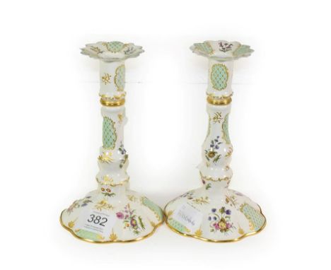 A pair of Halcyon Days Bilston style enamel candlesticks, 16cm high.  Good overall condition