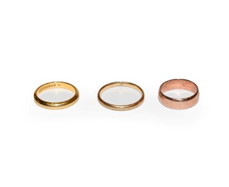 Three 9 carat gold band rings, finger sizes K, M and R.  Gross weight 8.2 grams. 