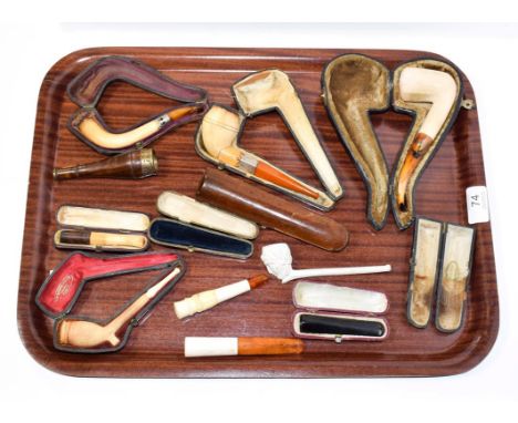 ~ A collection of cased meerschaum pipes, cheroot holders and a figural clay pipe (1 tray)