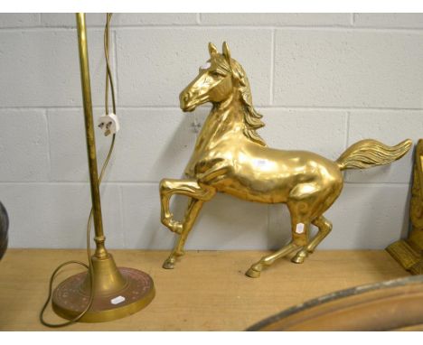 A brass statue of a stallion mid canter, 68cm long together with a brass adjustable table lamp (2)