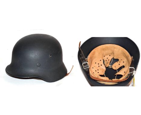 A copy of a German Third Reich M40 army helmet, with dark green/grey  'Rauhlack' finish, leather eight tongue liner and chins