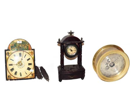 ~ A Continental twin weight hanging alarm clock striking on a bell, a quartz portico mantel timepiece and a brass cased anero