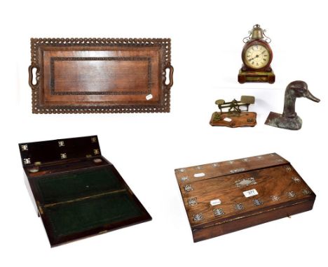 A 19th century rosewood mother of pearl inlaid writing slope, Indian carved wooden serving tray, postal scales, German alarm 