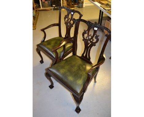 Pair of 20th Century mahogany Chippendale style open armchairs with carved pierced backs and drop-in green leather upholstere