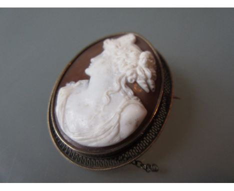 Victorian oval carved shell cameo portrait brooch with a yellow metal filigree mount