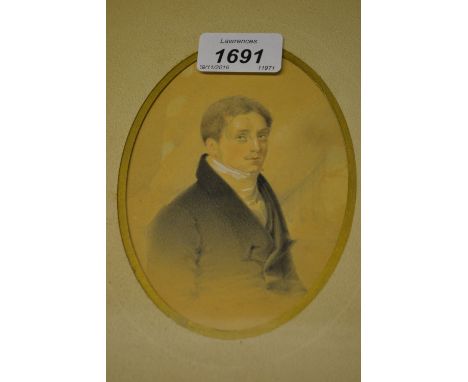 19th Century English school watercolour, half length portrait of a gentleman, oval mounted, together with a charcoal portrait