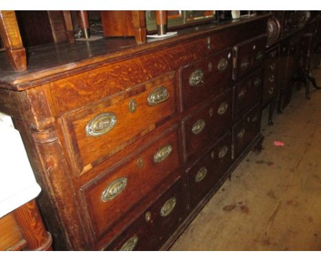 George III oak and mahogany crossbanded mule chest, the hinged lid above six simulated and three real drawers with oval brass